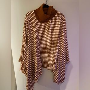 Burnt orange turtleneck poncho.